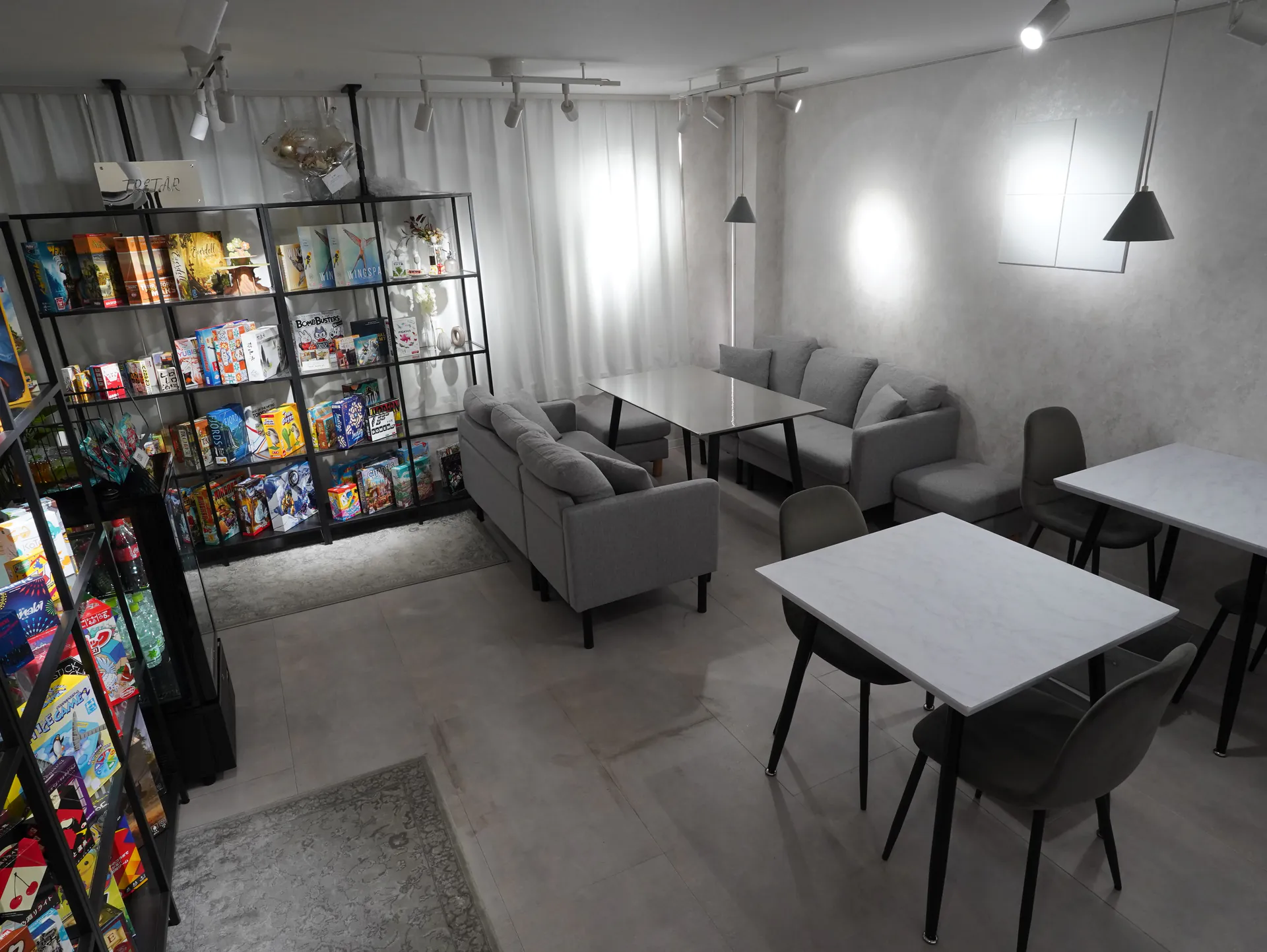 ボードゲームの棚に囲まれた明るく落ち着いた店内